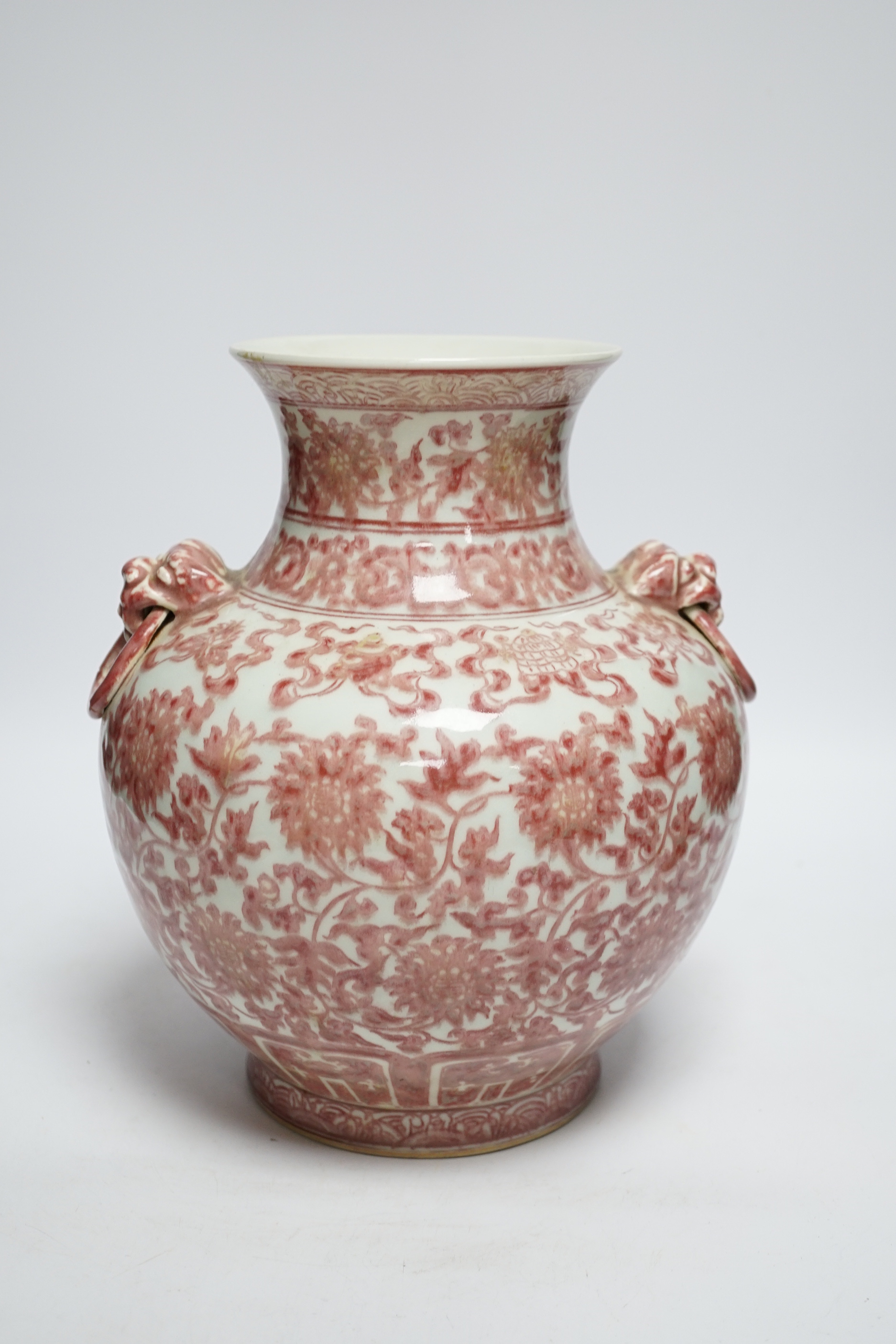 A Chinese underglaze copper red floral vase with twin handles, 27cm high